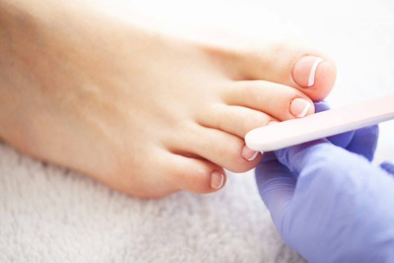 Pedicure Day. Pedicure Specialist Works With the Patient in Spa Salon